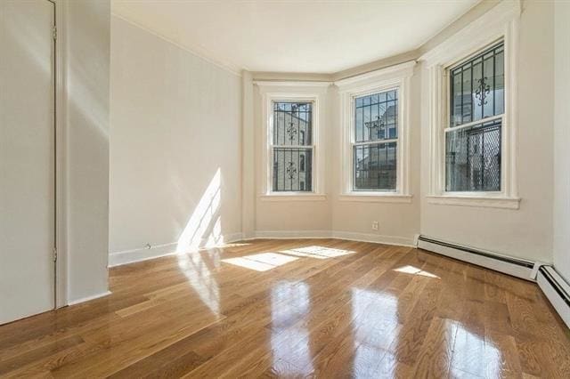 198 Myrtle Ave, Jersey City, NJ 07305 - unfurnished room featuring a baseboard radiator and wood finished floors