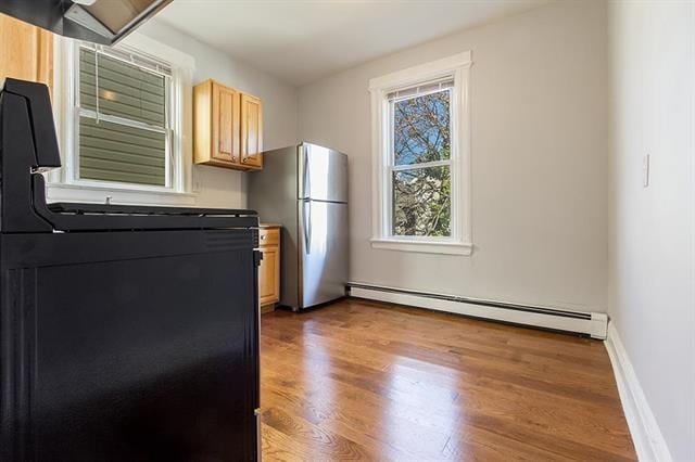 198 Myrtle Ave, Jersey City, NJ 07305 - kitchen with freestanding refrigerator, baseboard heating, wood finished floors, and light brown cabinets