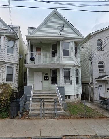 198 Myrtle Ave, Jersey City, NJ 07305 - view of property featuring a balcony, a fenced front yard, covered porch, and a gate