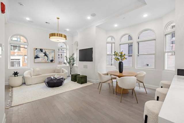 living room featuring crown molding and light hardwood / wood-style floors