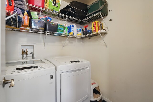 clothes washing area featuring washing machine and clothes dryer and laundry area