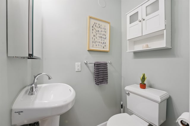 half bath with toilet and a sink