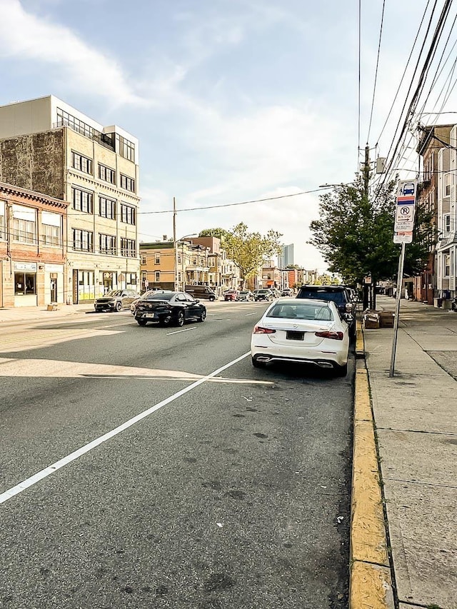 3481 John F Kennedy Blvd Unit 301, Jersey City, NJ 07307 - view of asphalt road with curbs, sidewalks, traffic signs, and street lights