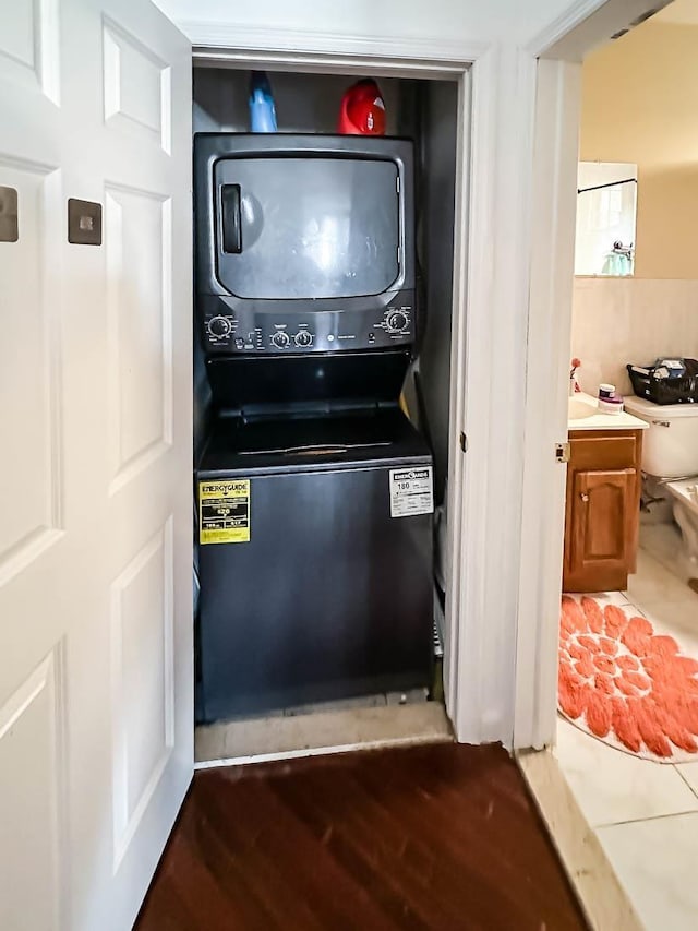 3481 John F Kennedy Blvd Unit 301, Jersey City, NJ 07307 - laundry room with stacked washer / drying machine and wood finished floors
