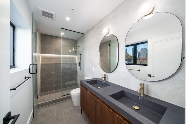 bathroom featuring vanity, an enclosed shower, and toilet