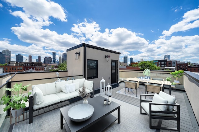 view of patio with an outdoor living space with a fire pit and a deck