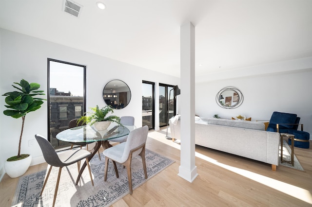 dining space with light hardwood / wood-style floors