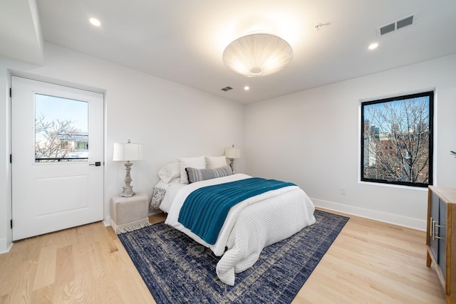 bedroom featuring multiple windows and light wood-type flooring