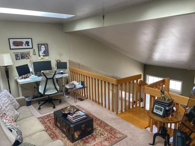 office featuring carpet and lofted ceiling