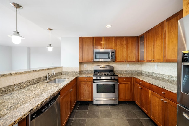 kitchen featuring stainless steel appliances, brown cabinets, and a sink