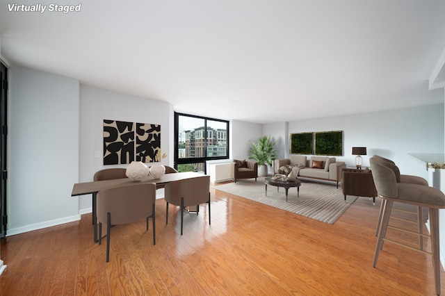 dining room featuring light wood finished floors and baseboards