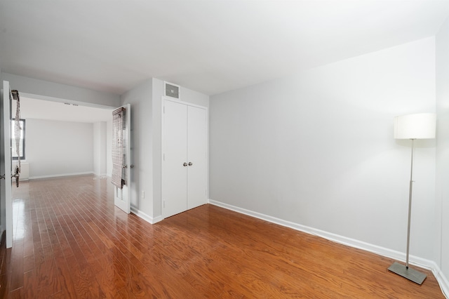 interior space featuring wood finished floors, visible vents, and baseboards