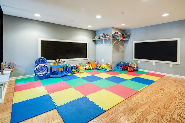 game room with recessed lighting, baseboards, and wood finished floors