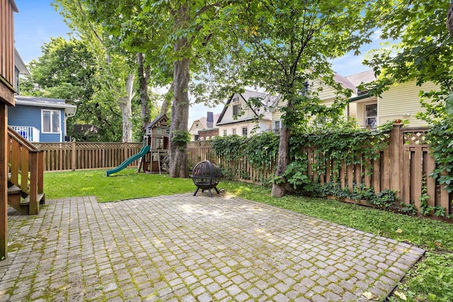 5 Bonn Pl, Weehawken, NJ 07086 - fenced backyard with a patio area, a playground, and a fire pit