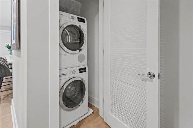 9 Avenue At Port Imperial Unit 313, West New York, NJ 07093 - washroom featuring stacked washer / dryer and wood finished floors
