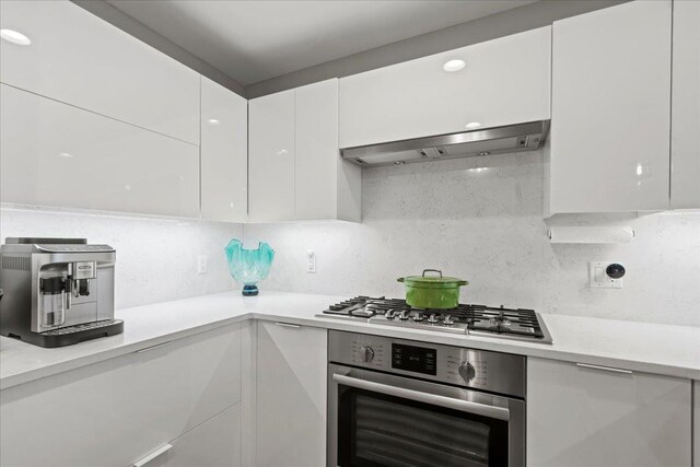 9 Avenue At Port Imperial Unit 313, West New York, NJ 07093 - kitchen featuring stainless steel appliances, modern cabinets, wall chimney range hood, white cabinets, and light countertops