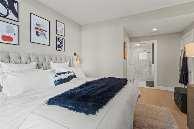 9 Avenue At Port Imperial Unit 313, West New York, NJ 07093 - bedroom featuring wood finished floors, recessed lighting, baseboards, and ensuite bath