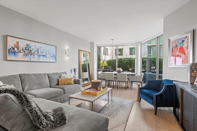 9 Avenue At Port Imperial Unit 313, West New York, NJ 07093 - living room with light wood finished floors and a wall of windows
