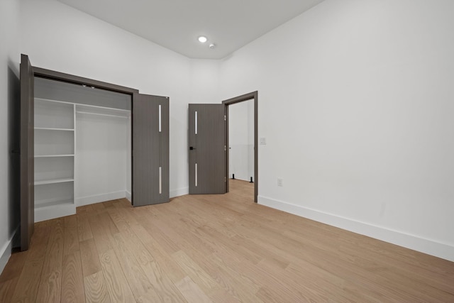 248 New York Ave Unit 1, Jersey City, NJ 07307 - unfurnished bedroom with light wood finished floors, baseboards, and a closet
