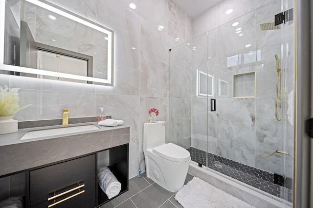 248 New York Ave Unit 1, Jersey City, NJ 07307 - bathroom featuring tile walls, vanity, toilet, a stall shower, and tile patterned floors