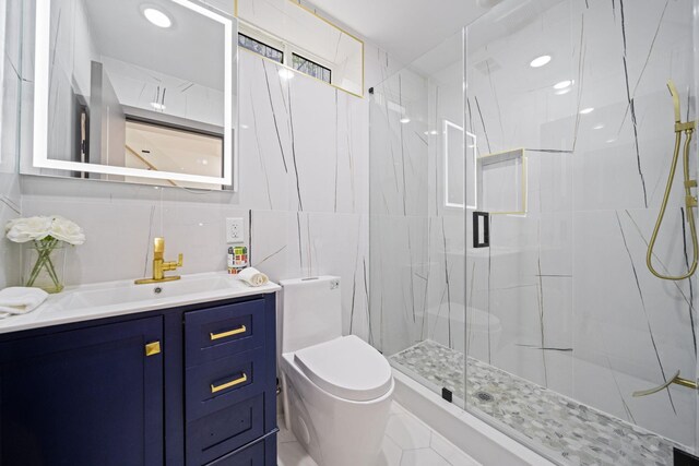 248 New York Ave Unit 1, Jersey City, NJ 07307 - bathroom with toilet, vanity, a marble finish shower, and tile walls