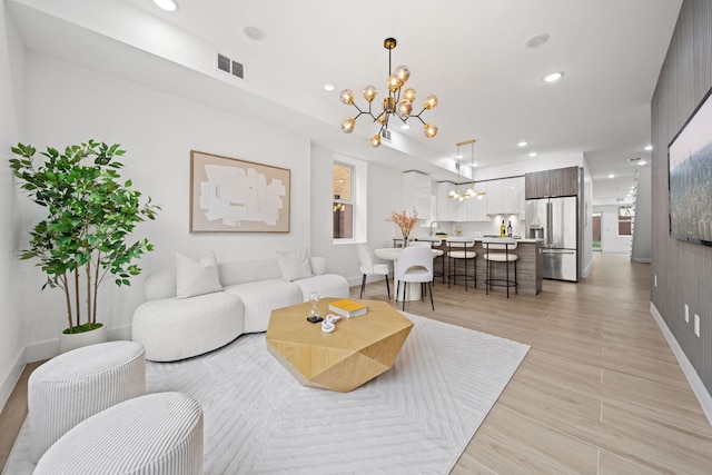 248 New York Ave Unit 1, Jersey City, NJ 07307 - living area featuring a chandelier, recessed lighting, baseboards, and light wood-style floors