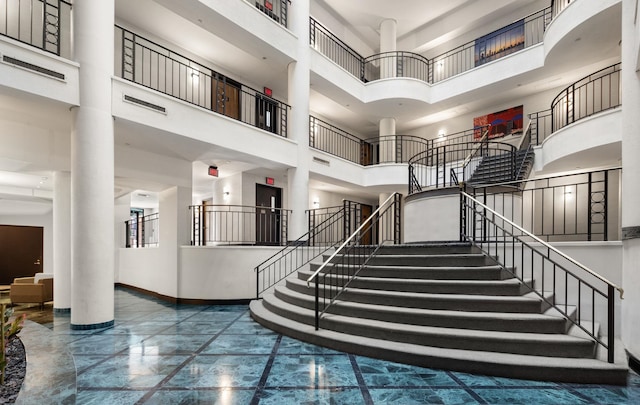 1 Greene St Unit 710, Jersey City, NJ 07302 - staircase featuring a high ceiling, marble tiled floors, and ornate columns