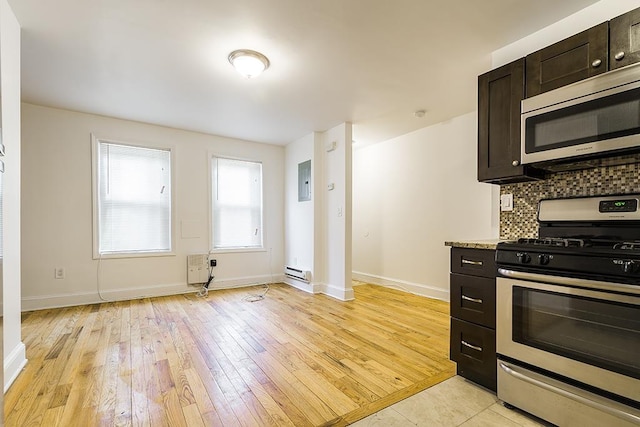 kitchen featuring decorative backsplash, a baseboard radiator, dark brown cabinets, light hardwood / wood-style floors, and stainless steel appliances