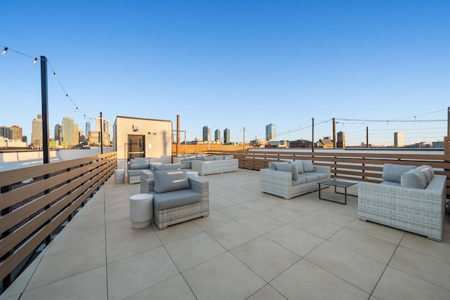 view of patio with an outdoor living space and a city view