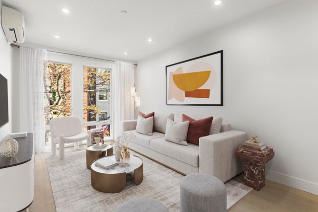 dining area with an AC wall unit and light hardwood / wood-style flooring