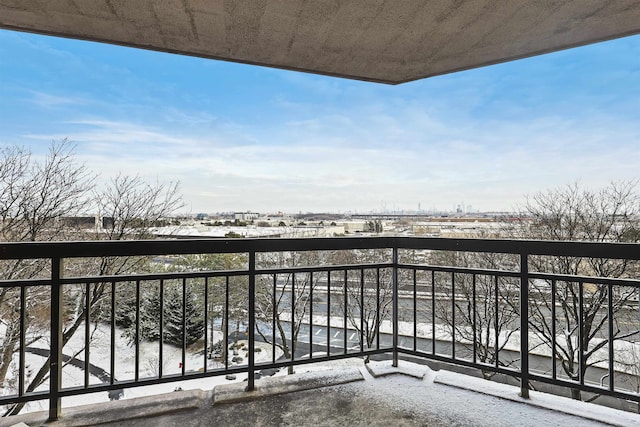 view of snow covered back of property