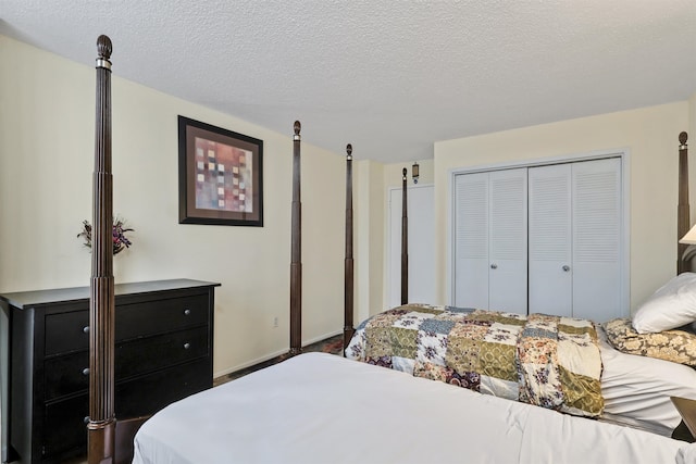 bedroom with a textured ceiling and a closet