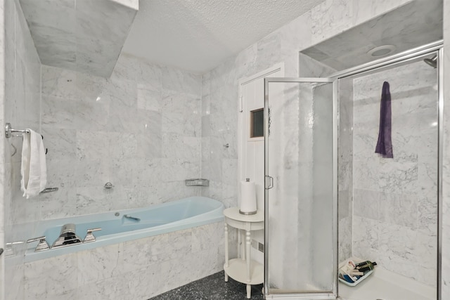 bathroom with a textured ceiling, tile walls, and shower with separate bathtub