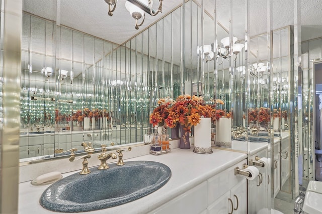 bathroom with vanity and a textured ceiling