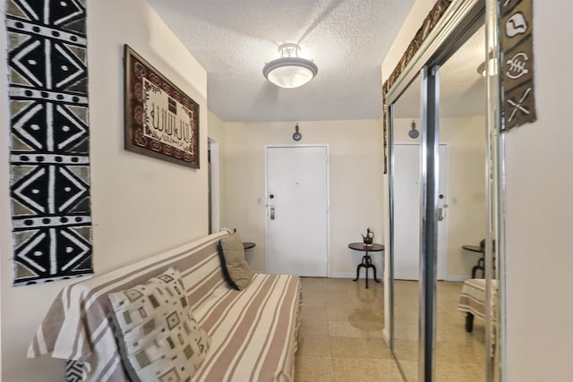 hallway with a textured ceiling