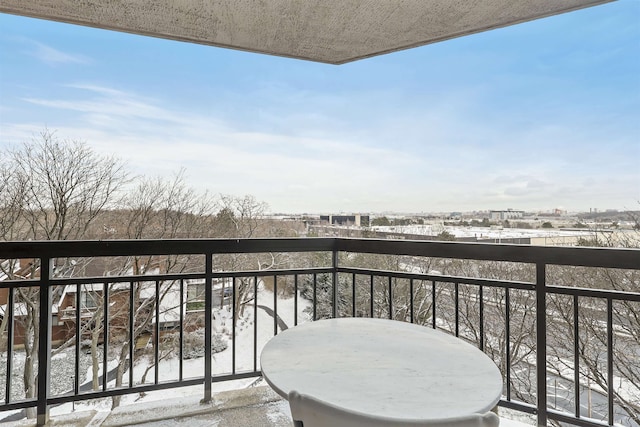 view of snow covered back of property