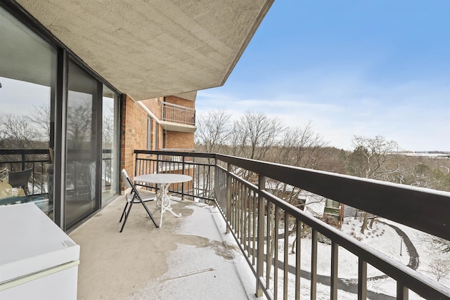 view of snow covered back of property