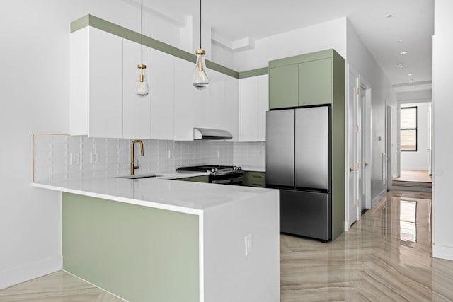 322 3rd St Unit 1, Jersey City, NJ 07302 - kitchen with freestanding refrigerator, a peninsula, wall chimney range hood, gas range, and backsplash