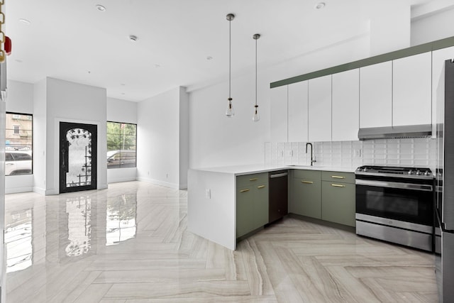 322 3rd St Unit 1, Jersey City, NJ 07302 - kitchen with appliances with stainless steel finishes, tasteful backsplash, under cabinet range hood, light countertops, and white cabinetry