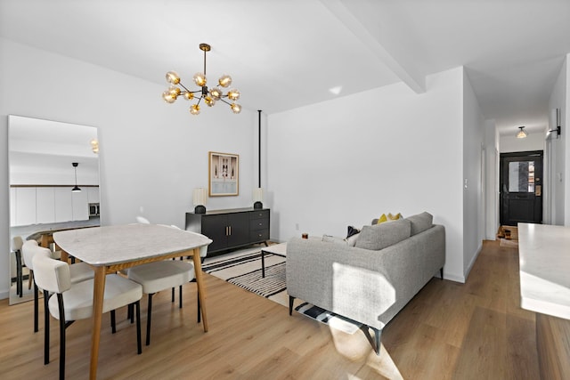 living room featuring light hardwood / wood-style flooring, a chandelier, and beamed ceiling