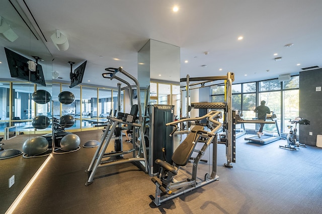 gym with a wall of windows