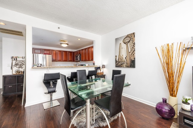 dining room featuring baseboards, dark wood-type flooring, recessed lighting, and visible vents