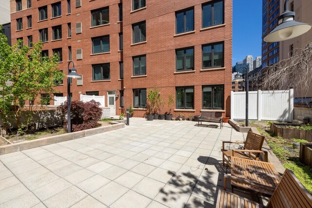 view of property's community with entry steps and a patio area