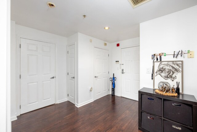 interior space with recessed lighting, baseboards, dark wood finished floors, and visible vents