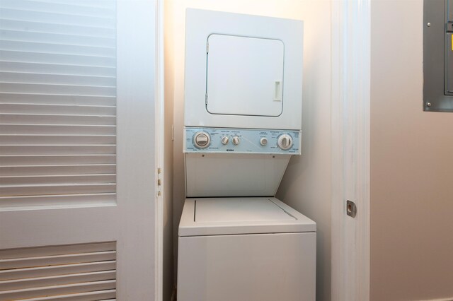 washroom with laundry area and stacked washer / dryer