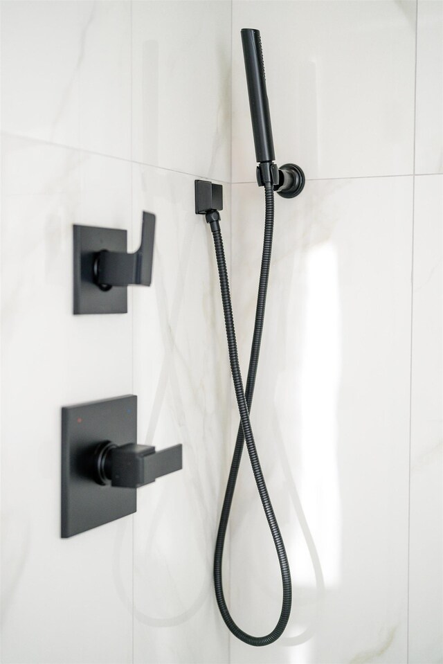 interior details featuring tiled shower