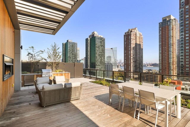 43 Provost St Unit 10O, Jersey City, NJ 07302 - wooden deck with a skyline view and outdoor dining space