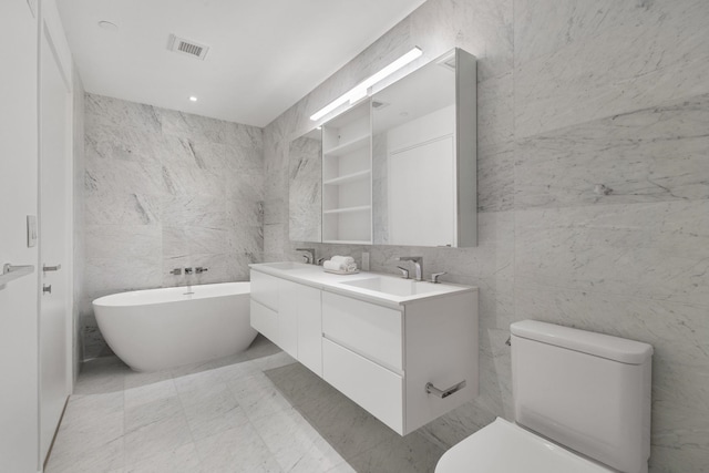43 Provost St Unit 10O, Jersey City, NJ 07302 - full bath with double vanity, tile walls, a soaking tub, toilet, and recessed lighting