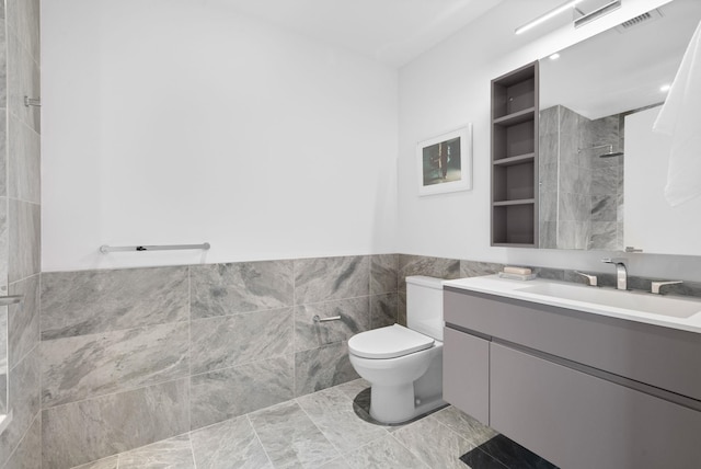 43 Provost St Unit 10O, Jersey City, NJ 07302 - full bathroom featuring tile walls, vanity, toilet, a tile shower, and a wainscoted wall