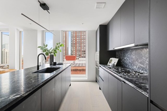 43 Provost St Unit 10O, Jersey City, NJ 07302 - kitchen with a sink, tasteful backsplash, appliances with stainless steel finishes, and plenty of natural light